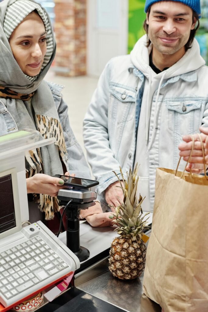 A couple making payment in the Supermarket using Google Pay.